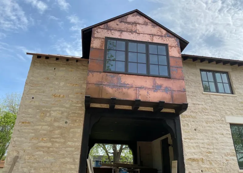 Copper metal panel facade on a stone building for Skylight Installation in Kenosha