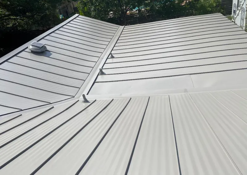 Solar attic fan installed on a metal roof for Roof Ventilation in Kenosha